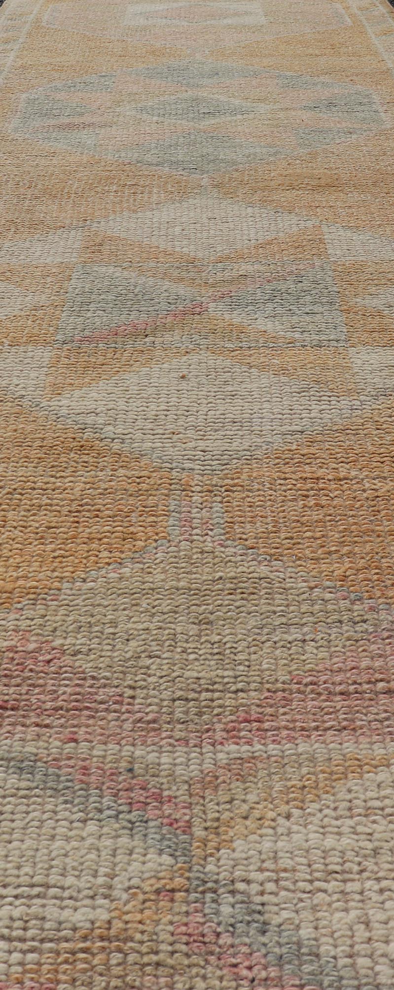 Tribal Medallion Vintage Turkish Oushak Runner in Orange, Blue and Cream Measures: 2'9 x 12'0 This very unique Oushak is uncommon in its design, from the bright and creamy orange background to the angular and sharp medallions center... - Keivan Woven ArtsTU - MTU - 15 - 18728
