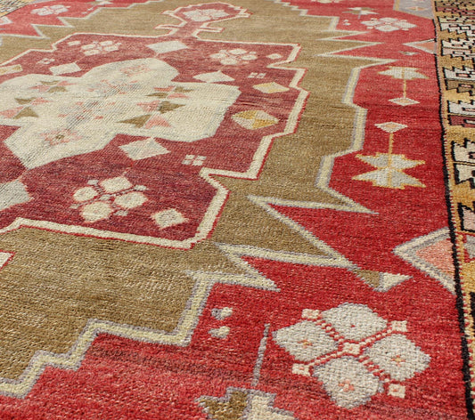 Unique Vintage Turkish Oushak Rug with Geometric Medallion in Red, Green, Yellow, rug mtu - 3468, country of origin / type: Turkey / Oushak, circa mid - 20th century This vintage Turkish Oushak rug (circa mid - 20th century) features a unique blend of... - Keivan Woven ArtsTU - MTU - 3468 - 6215Rug