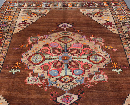 Vintage Turkish Kars Rug With Medallion On A Brown Field with Pops of Color. Keivan Woven Arts / rug/ TU - MTU - 3489, country of origin / type: Turkey / Oushak / Kars, circa 1940 Measures: 9'4 x 10'2. This Turkish Kars rug has been handwoven in Turk... - Keivan Woven ArtsTU - MTU - 3489 - 6853Rug