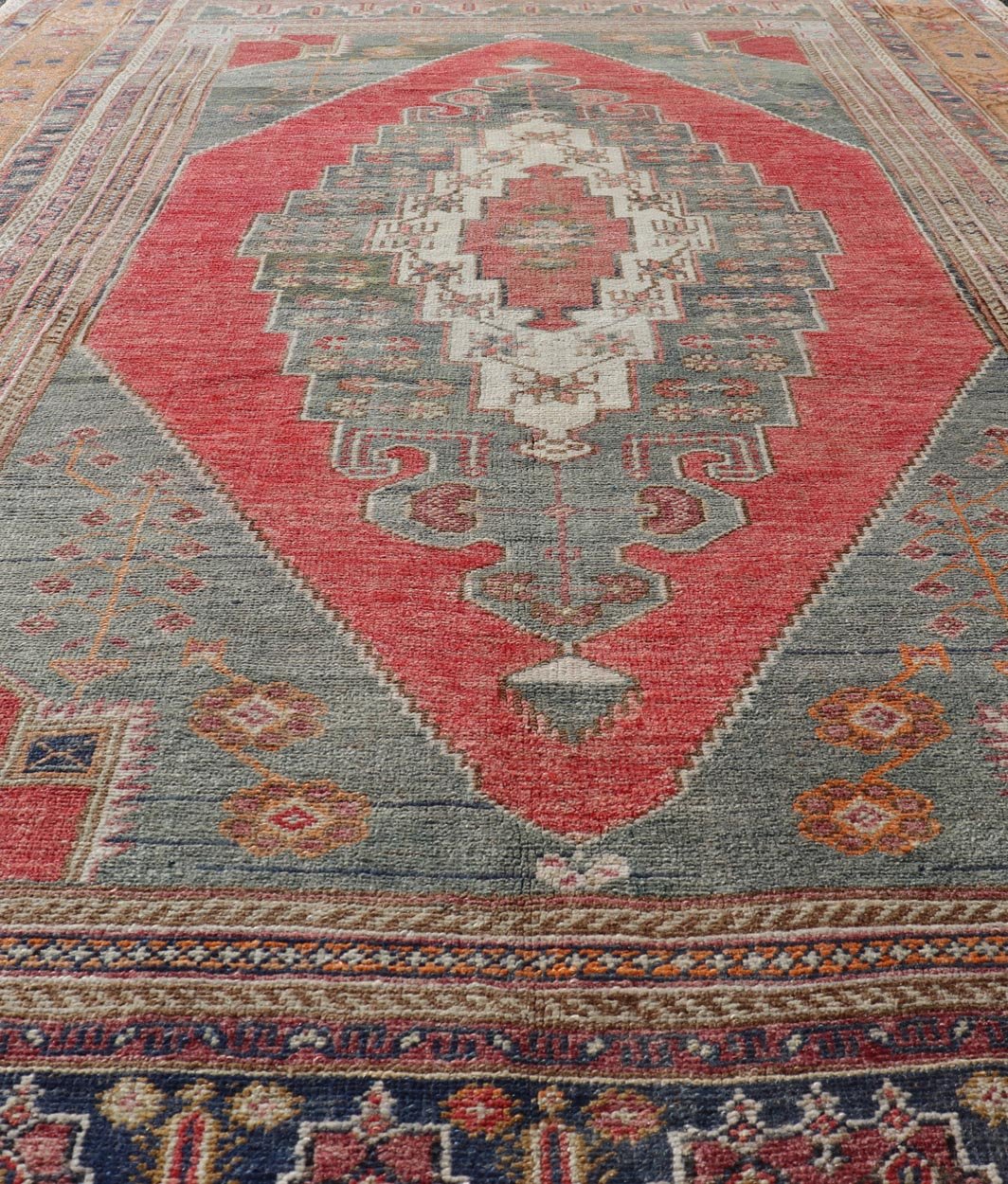 Vintage Turkish Oushak Rug Medallion Design in Red, Gray, and Orange. Measures: 5'7 x 9'11 Vintage Turkish Oushak Rug Medallion Design in Red, Gray, and Orange. Keivan Woven Arts / rug TU - MTU - 4658, country of origin / type: Turkey / Oushak, circ... - Keivan Woven ArtsTU - MTU - 4658 - 22009Rug