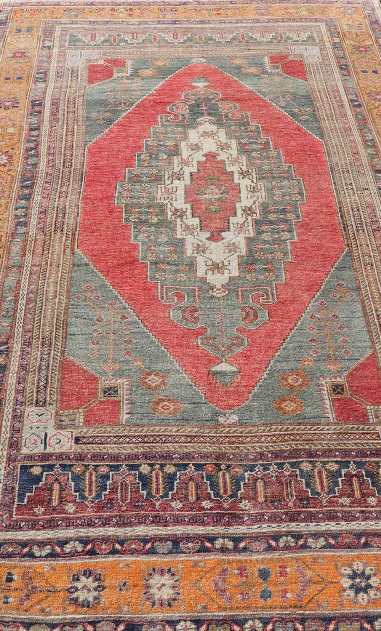 Vintage Turkish Oushak Rug Medallion Design in Red, Gray, and Orange. Measures: 5'7 x 9'11 Vintage Turkish Oushak Rug Medallion Design in Red, Gray, and Orange. Keivan Woven Arts / rug TU - MTU - 4658, country of origin / type: Turkey / Oushak, circ... - Keivan Woven ArtsTU - MTU - 4658 - 22009Rug