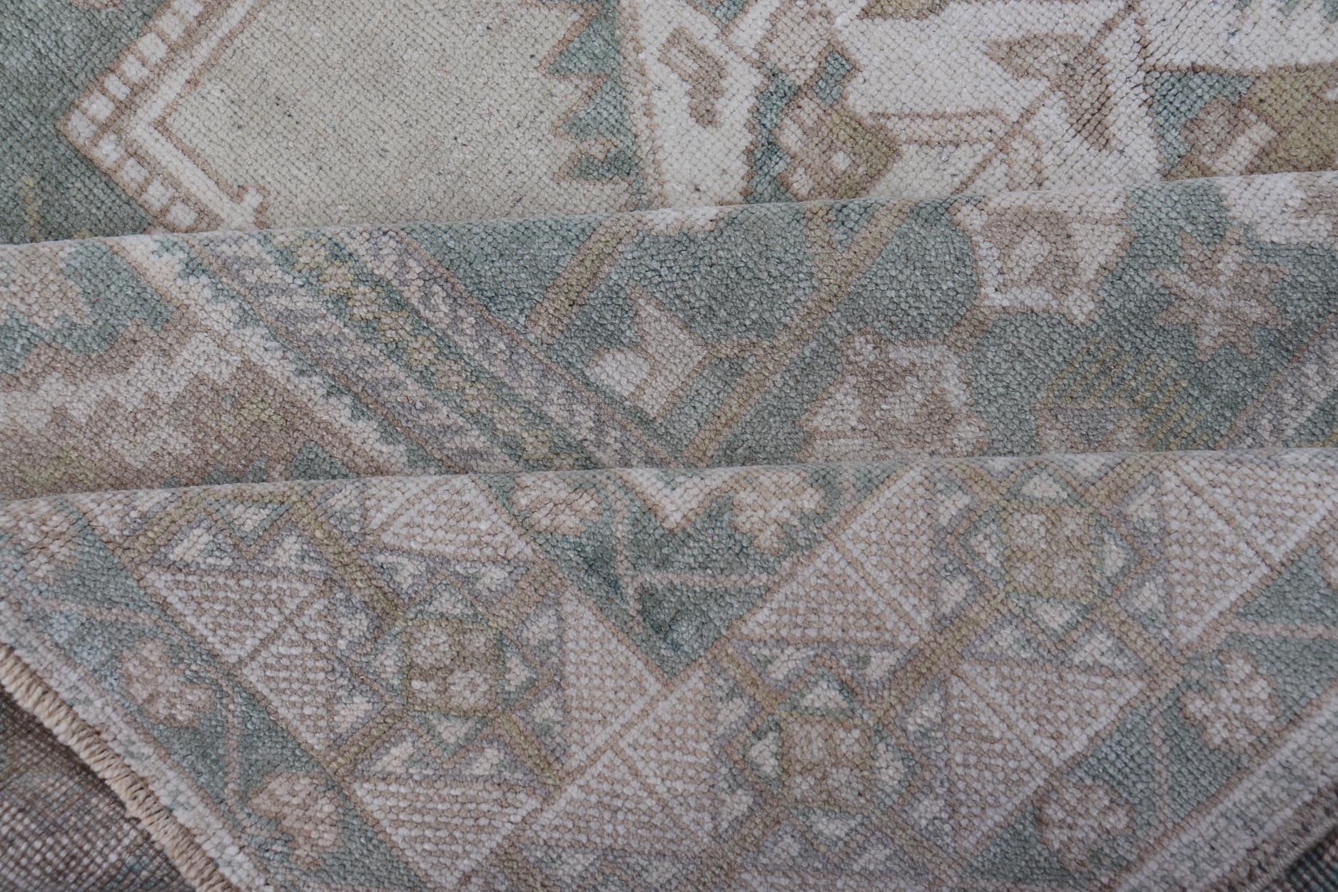 Measures: 6'4 x 11'9 Turkish Vintage Oushak Rug With Medallion in Muted Light Green and Cream. Keivan Woven Arts / rug TU - MTU - 4665 country of origin / type: Turkey / circa 1940 This vintage muted Turkish Oushak Rug has been hand - knotted in ... - Keivan Woven ArtsTU - MTU - 4665 - 22039Rug