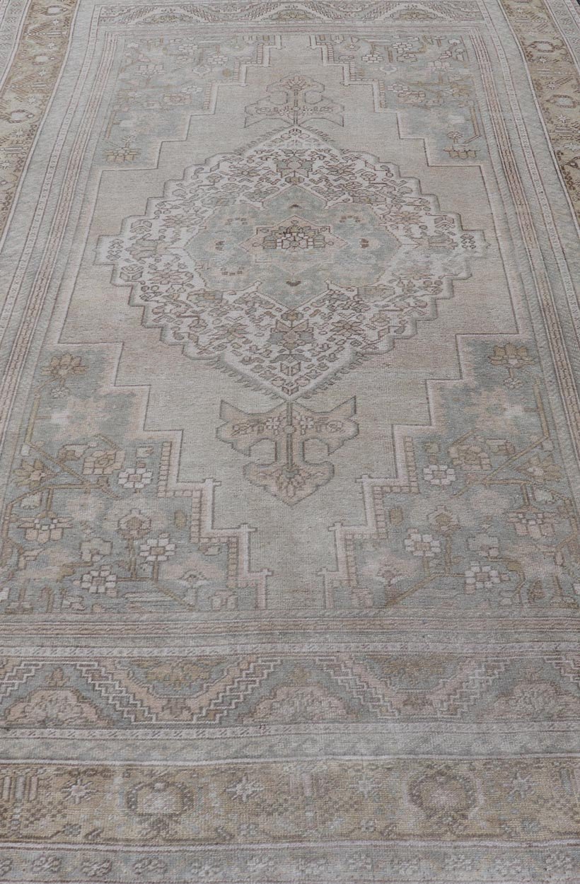 Measures: 6'8 x 12'2 Vintage Turkish Floral Medallion Oushak Rug in Light Brown and Light Blue. Country of origin: Turkey; Type: Oushak; Design: Medallion, Floral Medallion; Keivan Woven Arts: rug / TU - MTU - 4666. mid - 20 - th century. Set on a k... - Keivan Woven ArtsTU - MTU - 4666 - 22045Rug