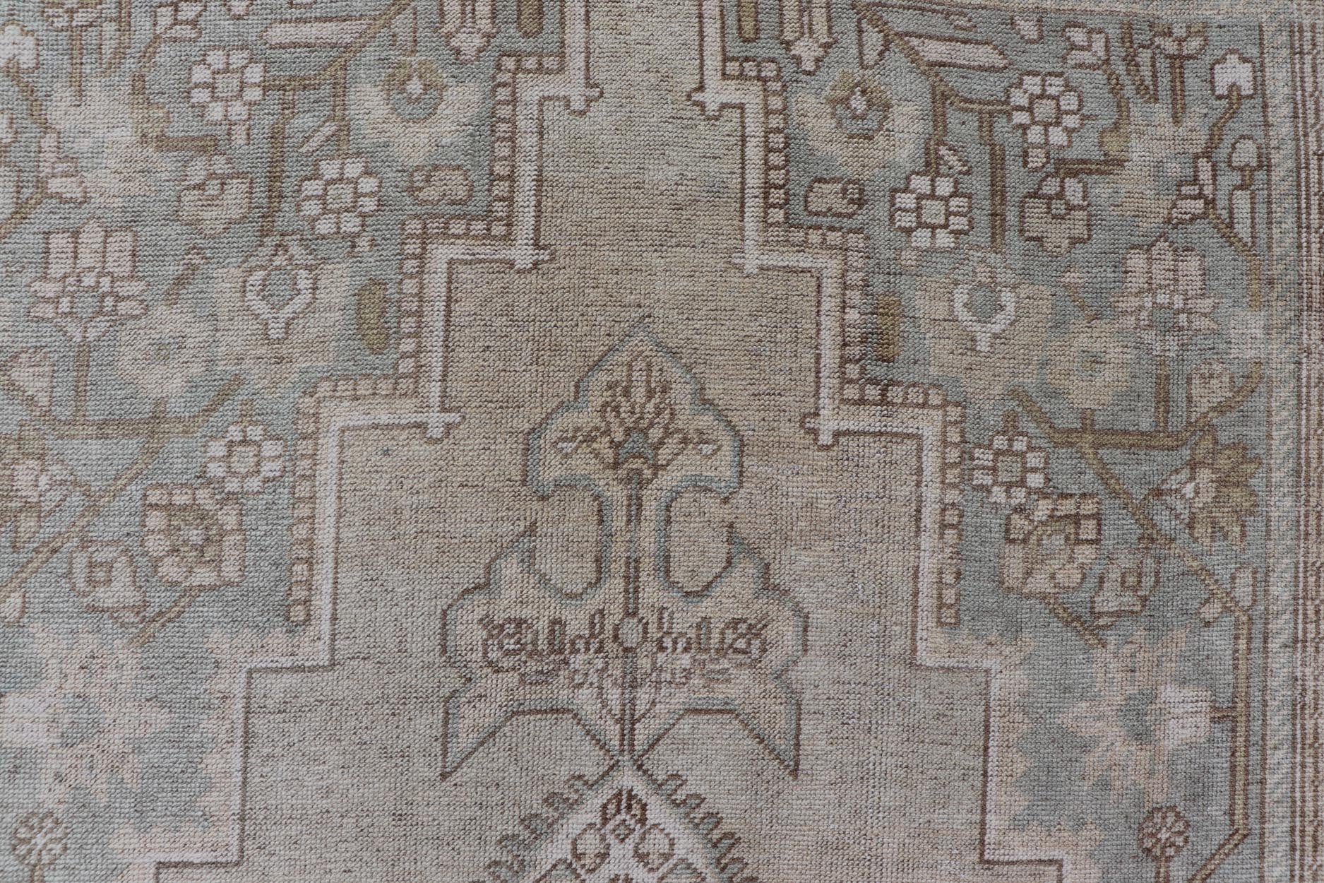 Measures: 6'8 x 12'2 Vintage Turkish Floral Medallion Oushak Rug in Light Brown and Light Blue. Country of origin: Turkey; Type: Oushak; Design: Medallion, Floral Medallion; Keivan Woven Arts: rug / TU - MTU - 4666. mid - 20 - th century. Set on a k... - Keivan Woven ArtsTU - MTU - 4666 - 22045Rug