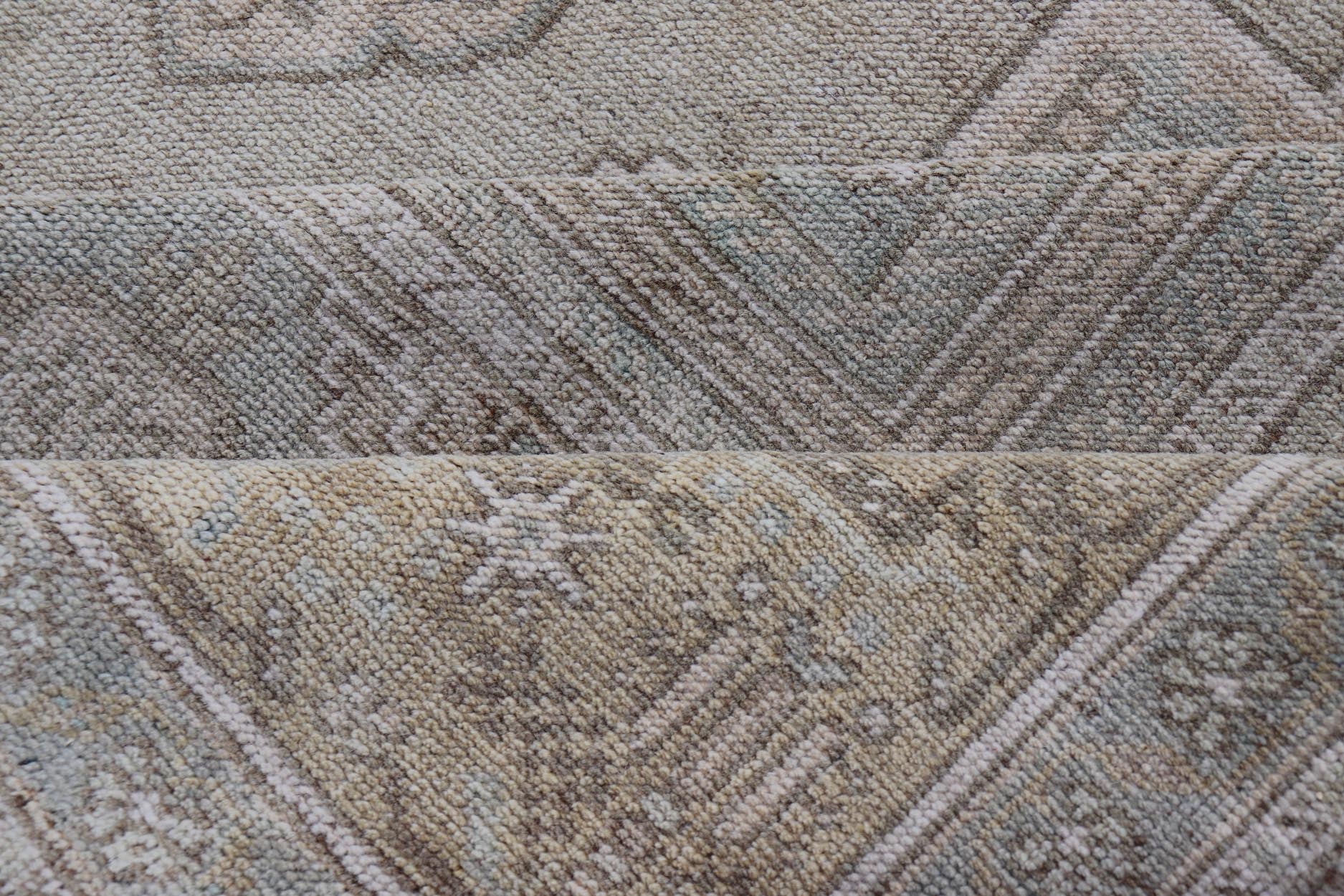 Measures: 6'8 x 12'2 Vintage Turkish Floral Medallion Oushak Rug in Light Brown and Light Blue. Country of origin: Turkey; Type: Oushak; Design: Medallion, Floral Medallion; Keivan Woven Arts: rug / TU - MTU - 4666. mid - 20 - th century. Set on a k... - Keivan Woven ArtsTU - MTU - 4666 - 22045Rug