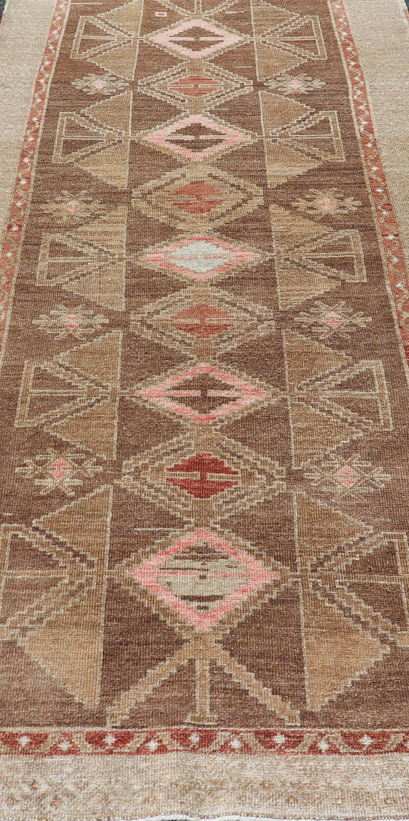 Hand Knotted Colorful Turkish Kars with Tribal Designs and Geometric Motifs Vintage Turkish in Brown background and taupe border with accent colors, red, pink, tan, green, taupe. Keivan Woven Arts / rug /TU - MTU - 4880, country of origin / type: Tu... - Keivan Woven ArtsTU - MTU - 4880 - 18968Rug