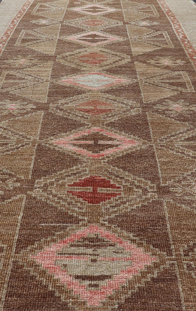Hand Knotted Colorful Turkish Kars with Tribal Designs and Geometric Motifs Vintage Turkish in Brown background and taupe border with accent colors, red, pink, tan, green, taupe. Keivan Woven Arts / rug /TU - MTU - 4880, country of origin / type: Tu... - Keivan Woven ArtsTU - MTU - 4880 - 18968Rug