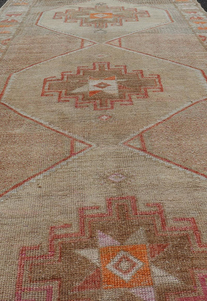 Vintage wide Gallery runner from Turkey with Medallion design in various tones of tan, taupe, orange, red, and browns. Keivan Woven Arts rug TU - MTU - 4955, country of origin / type: Turkey / Kars, circa 1940 Vintage Turkish Kars Runner in Brown Co... - Keivan Woven ArtsTU - MTU - 4955 - 19004Rug