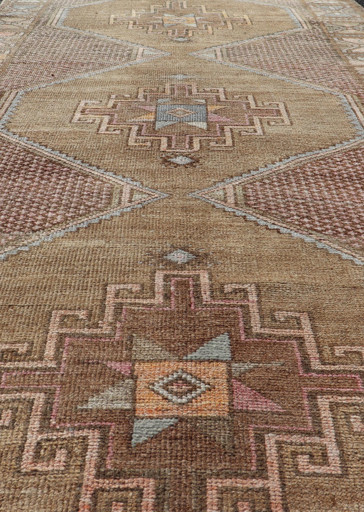 Unique & Colorful Turkish Kars Runner with Tribal Designs and Geometric Motifs Vintage Turkish runner in Brown background, accent colors, soft red, tan, green, light blue, taupe, rug/TU - MTU - 4956, country of origin / type: Turkey / Oushak, circa... - Keivan Woven ArtsTU - MTU - 4956 - 18649Rug