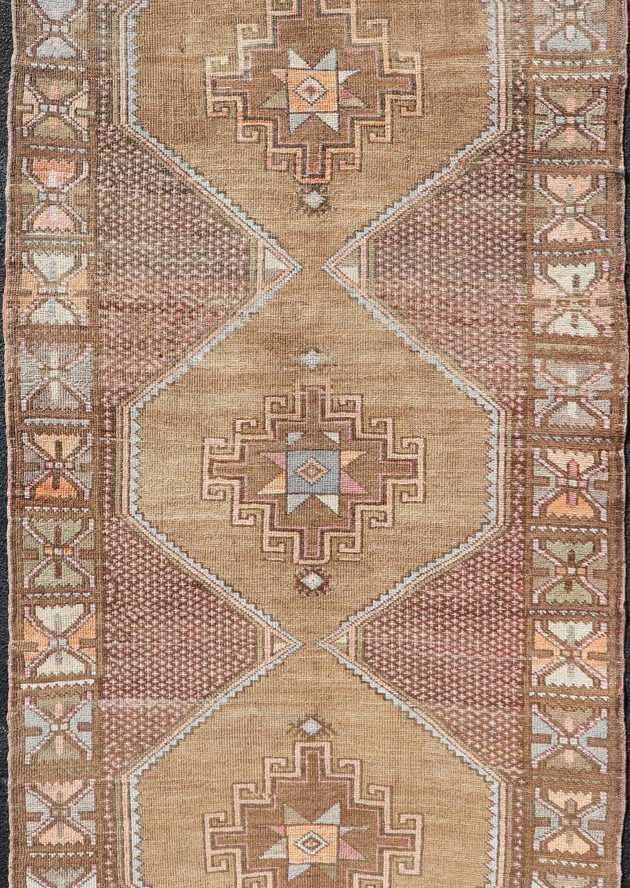 Unique & Colorful Turkish Kars Runner with Tribal Designs and Geometric Motifs Vintage Turkish runner in Brown background, accent colors, soft red, tan, green, light blue, taupe, rug/TU - MTU - 4956, country of origin / type: Turkey / Oushak, circa... - Keivan Woven ArtsTU - MTU - 4956 - 18649Rug