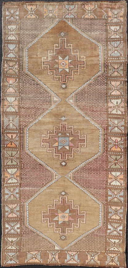 Unique & Colorful Turkish Kars Runner with Tribal Designs and Geometric Motifs Vintage Turkish runner in Brown background, accent colors, soft red, tan, green, light blue, taupe, rug/TU - MTU - 4956, country of origin / type: Turkey / Oushak, circa... - Keivan Woven ArtsTU - MTU - 4956 - 18649Rug