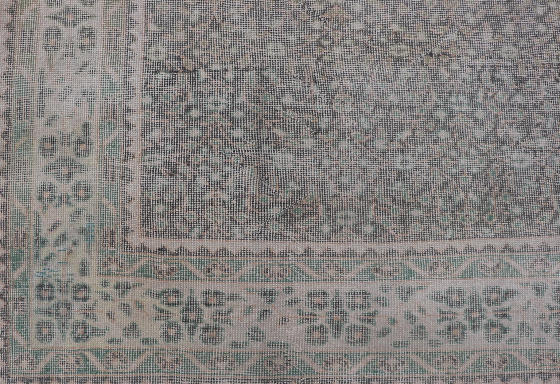 Vintage Hand - Knotted Distressed Turkish Rug in Wool with All - Over Floral Pattern This vintage Turkish Oushak rug has been hand - knotted in wool and features an all - over sub - geometric distressed floral design rendered in cream, blue, green and ivo... - Keivan Woven ArtsTU - MTU - 4962 - 19172