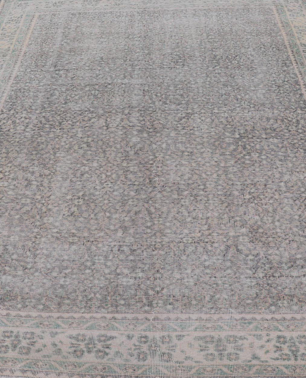 Vintage Hand - Knotted Distressed Turkish Rug in Wool with All - Over Floral Pattern This vintage Turkish Oushak rug has been hand - knotted in wool and features an all - over sub - geometric distressed floral design rendered in cream, blue, green and ivo... - Keivan Woven ArtsTU - MTU - 4962 - 19172