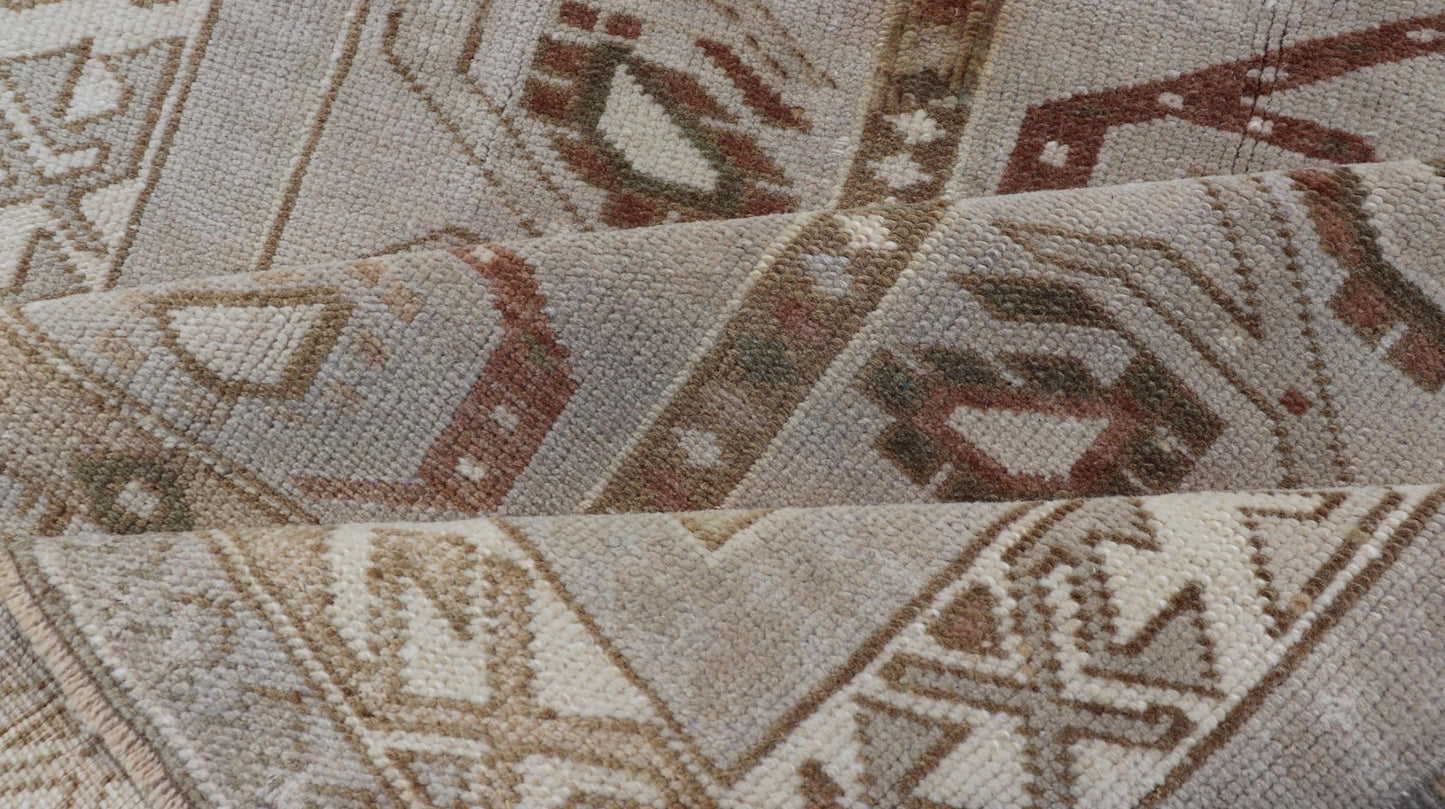 Measures: 3'5 x 6'2 This one - of - a - kind Turkish Oushak has a light taupe colored background reaching the field and the border. The unique tribal designs within the field are rendered in brick red, brown, and forest green. The complimentary borde... - Keivan Woven ArtsTU - MTU - 6003 - 19034
