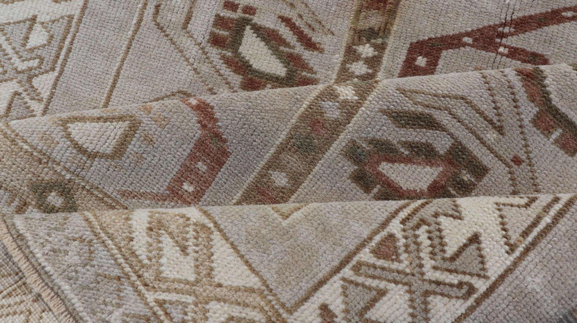 Measures: 3'5 x 6'2 This one - of - a - kind Turkish Oushak has a light taupe colored background reaching the field and the border. The unique tribal designs within the field are rendered in brick red, brown, and forest green. The complimentary borde... - Keivan Woven ArtsTU - MTU - 6003 - 19034