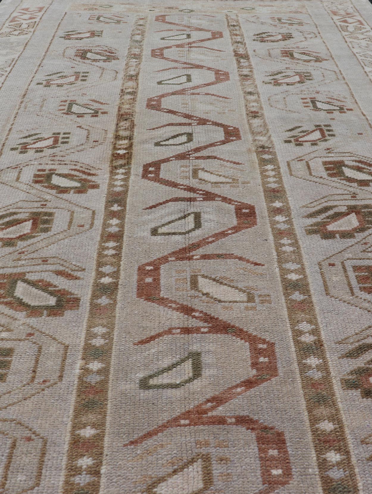 Measures: 3'5 x 6'2 This one - of - a - kind Turkish Oushak has a light taupe colored background reaching the field and the border. The unique tribal designs within the field are rendered in brick red, brown, and forest green. The complimentary borde... - Keivan Woven ArtsTU - MTU - 6003 - 19034