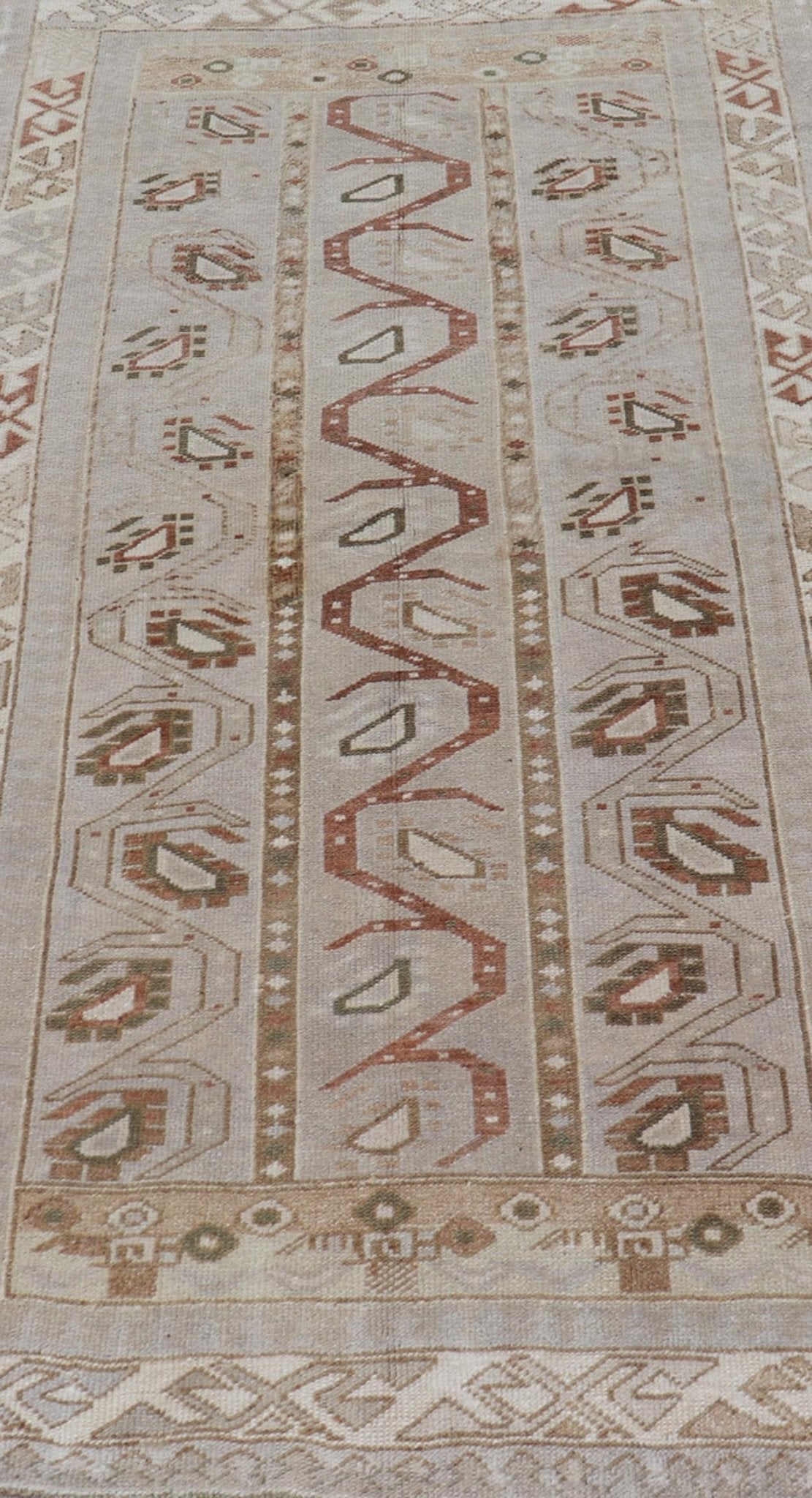 Measures: 3'5 x 6'2 This one - of - a - kind Turkish Oushak has a light taupe colored background reaching the field and the border. The unique tribal designs within the field are rendered in brick red, brown, and forest green. The complimentary borde... - Keivan Woven ArtsTU - MTU - 6003 - 19034