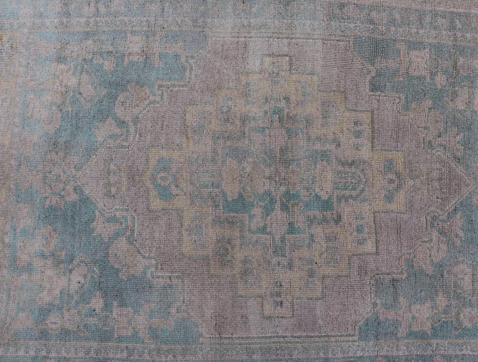 Light Colored Turkish Vintage Oushak Rug with Medallion Design Measures: 4'10 x 7'0 This vintage Turkish Oushak features a large central medallion and a complimentary stylized border. The charming palette consists of muted shades of bl... - Keivan Woven ArtsTU - MTU - 6006 - 19040Rug