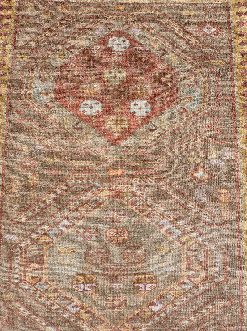 Measures: 2'11 x 10'11 Vintage Turkish Oushak Runner with Tribal Medallions in Brown's, Yellow, and Red. Keivan Woven Arts / rug TU - MTU - 936, country of origin / type: Turkey / Oushak, circa 1940. This vintage Oushak runner features a unique blen... - Keivan Woven ArtsTU - MTU - 936 - 21985Rug