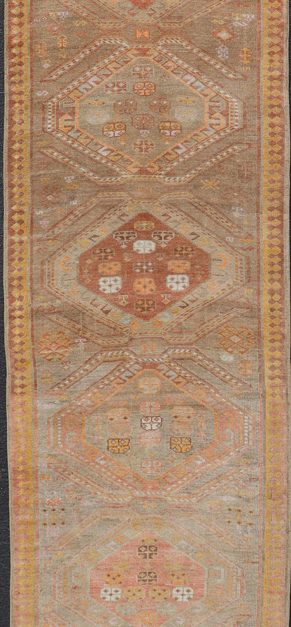 Measures: 2'11 x 10'11 Vintage Turkish Oushak Runner with Tribal Medallions in Brown's, Yellow, and Red. Keivan Woven Arts / rug TU - MTU - 936, country of origin / type: Turkey / Oushak, circa 1940. This vintage Oushak runner features a unique blen... - Keivan Woven ArtsTU - MTU - 936 - 21985Rug