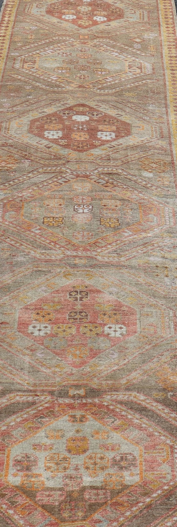 Measures: 2'11 x 10'11 Vintage Turkish Oushak Runner with Tribal Medallions in Brown's, Yellow, and Red. Keivan Woven Arts / rug TU - MTU - 936, country of origin / type: Turkey / Oushak, circa 1940. This vintage Oushak runner features a unique blen... - Keivan Woven ArtsTU - MTU - 936 - 21985Rug