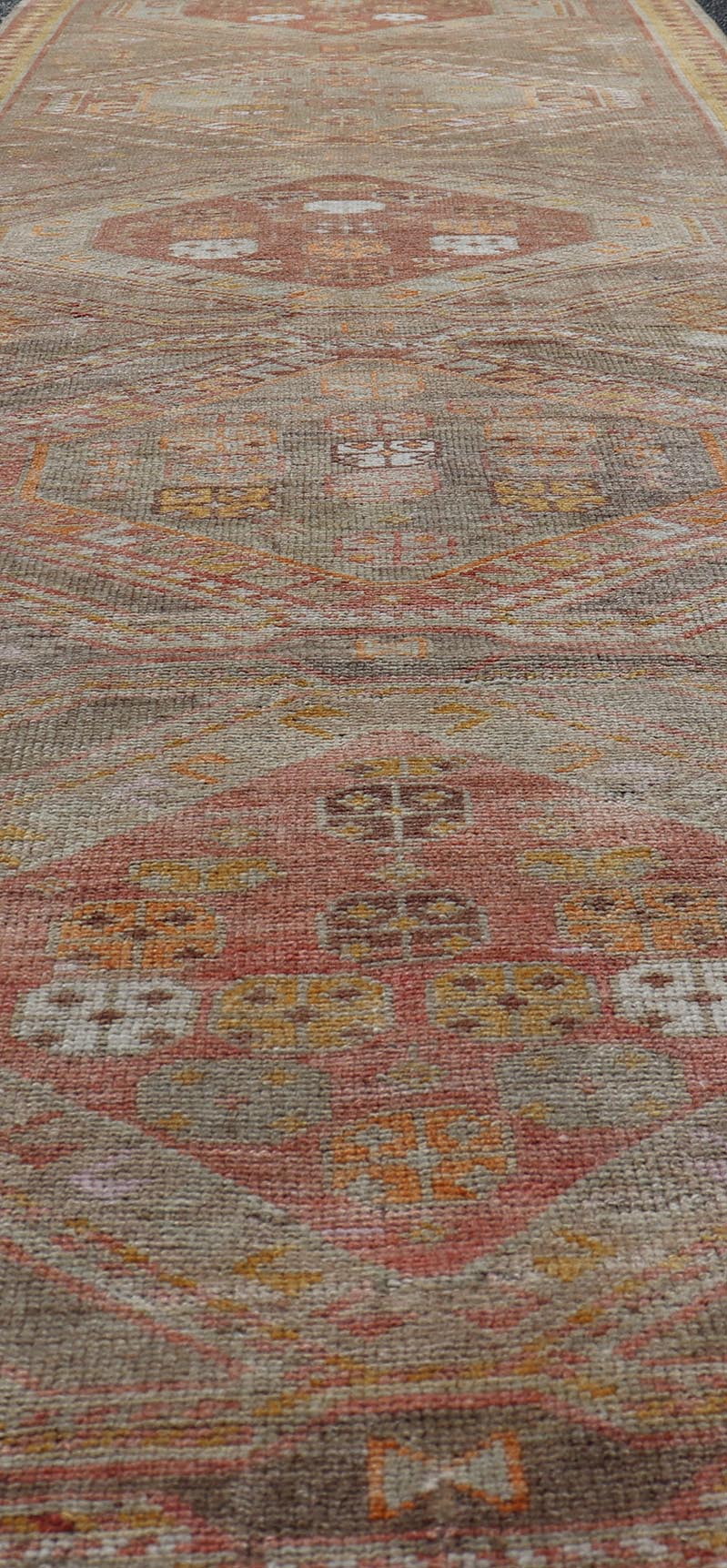 Measures: 2'11 x 10'11 Vintage Turkish Oushak Runner with Tribal Medallions in Brown's, Yellow, and Red. Keivan Woven Arts / rug TU - MTU - 936, country of origin / type: Turkey / Oushak, circa 1940. This vintage Oushak runner features a unique blen... - Keivan Woven ArtsTU - MTU - 936 - 21985Rug