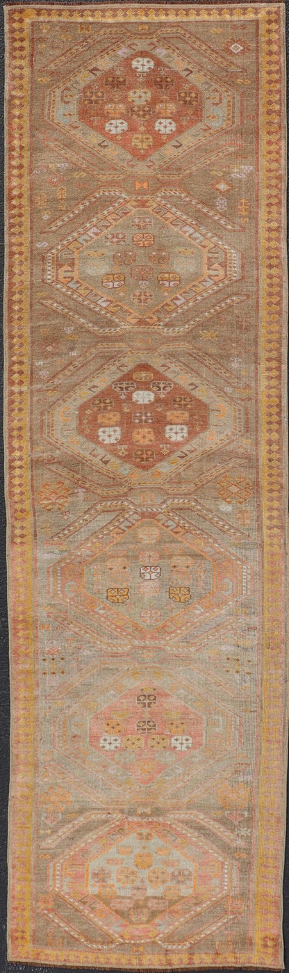 Measures: 2'11 x 10'11 Vintage Turkish Oushak Runner with Tribal Medallions in Brown's, Yellow, and Red. Keivan Woven Arts / rug TU - MTU - 936, country of origin / type: Turkey / Oushak, circa 1940. This vintage Oushak runner features a unique blen... - Keivan Woven ArtsTU - MTU - 936 - 21985Rug