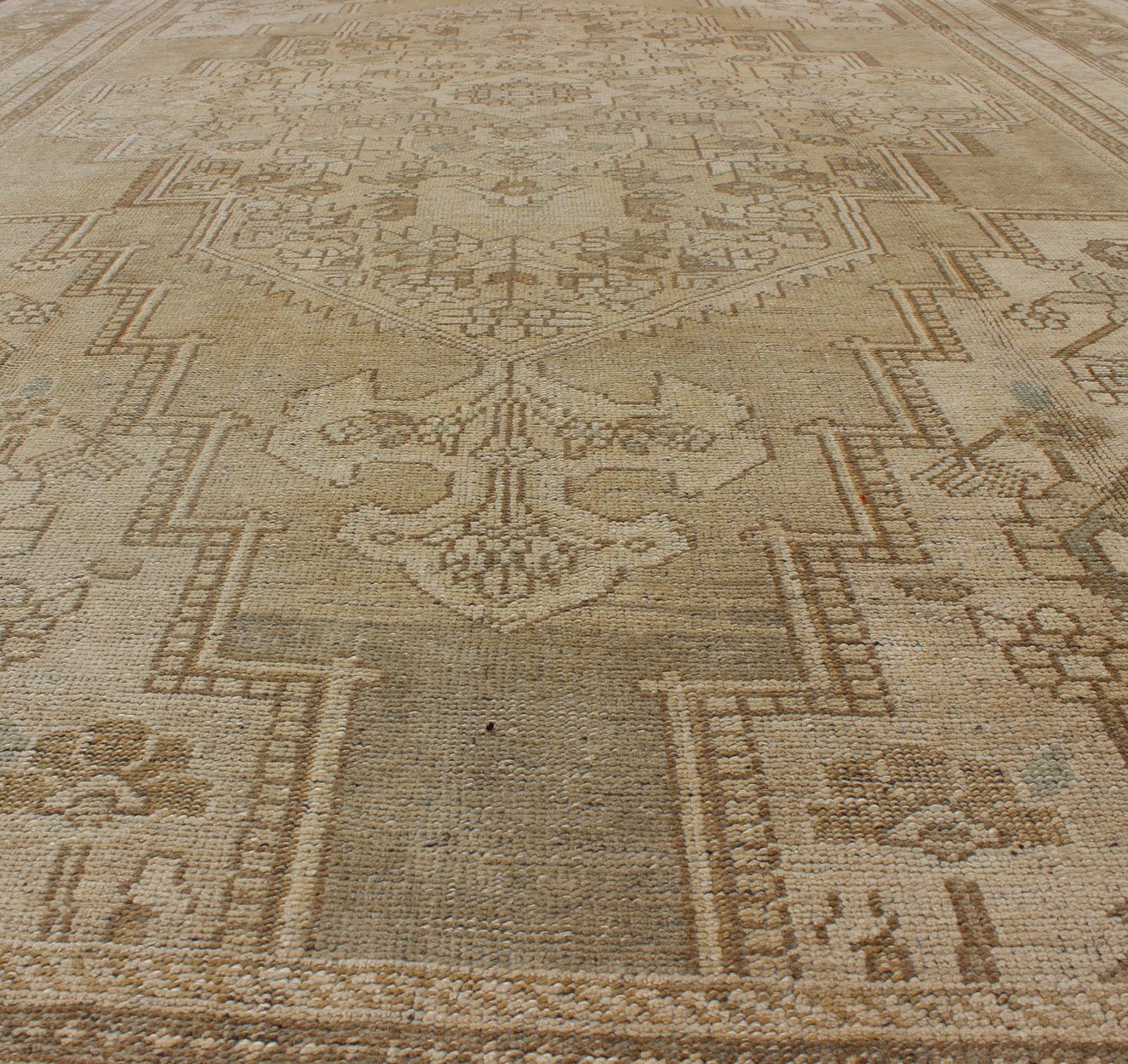Large Vintage Turkish Floral Medallion Oushak Rug in All Neutral Palette Measures: 7'3 x 13' This muted Turkish Oushak features a light khaki border and background with shades of beige. The corners and central medallion are composed of a... - Keivan Woven ArtsTU - MTU - 95085 - 3692Rug