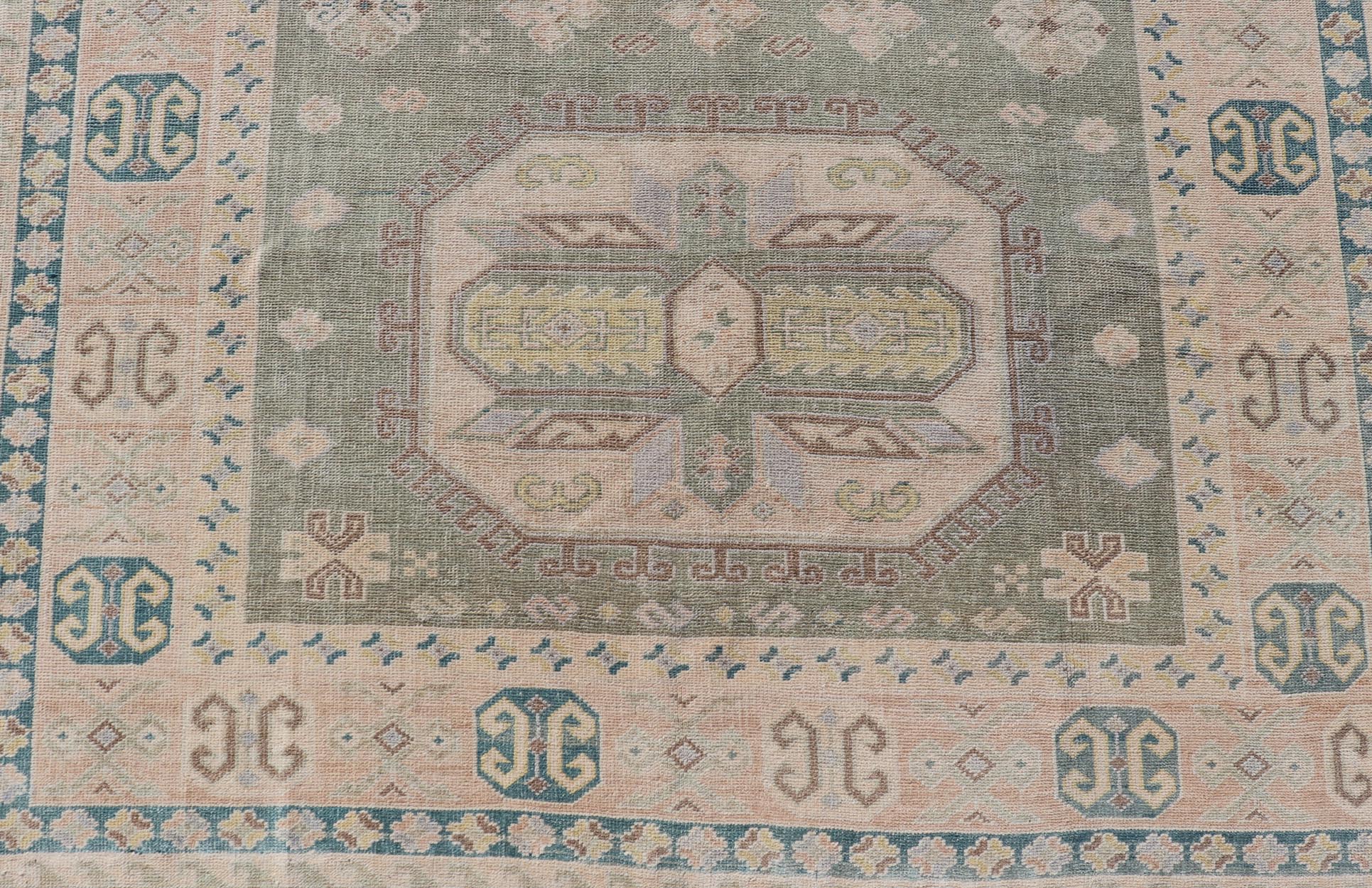 Measures: 6'0 x 9'10 Turkish Vintage Tribal Medallion Oushak in Muted Green, Blue, and Cream. Country of Origin: Turkey; Type: Oushak; Design: Medallion, Tribal Medallion, All - Over, Tribal; Keivan Woven Arts; rug TU - MTU - 991. mid - 20th century. ... - Keivan Woven ArtsTU - MTU - 991 - 21991Rug