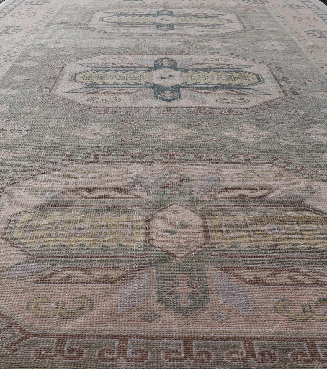 Measures: 6'0 x 9'10 Turkish Vintage Tribal Medallion Oushak in Muted Green, Blue, and Cream. Country of Origin: Turkey; Type: Oushak; Design: Medallion, Tribal Medallion, All - Over, Tribal; Keivan Woven Arts; rug TU - MTU - 991. mid - 20th century. ... - Keivan Woven ArtsTU - MTU - 991 - 21991Rug