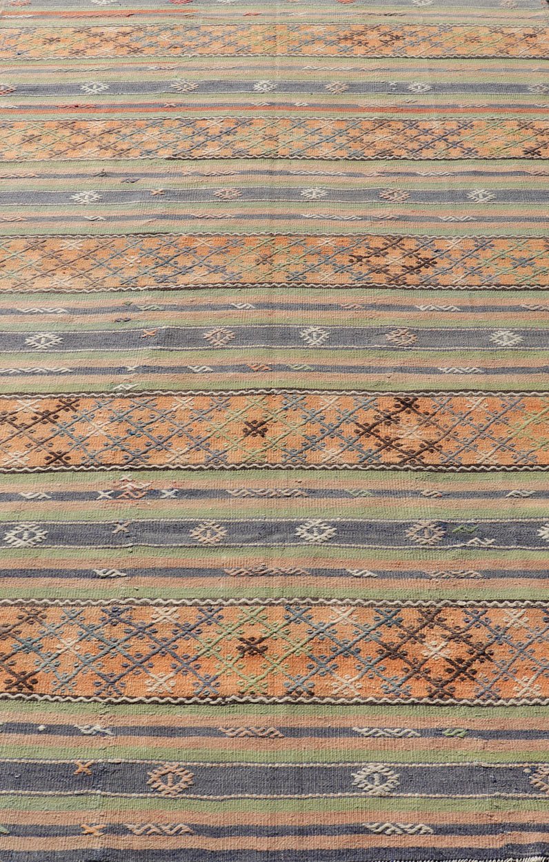 Colorful Turkish Kilim with Stripes and Geometric Motifs in Orange and Green Colorful Turkish Kilim rug with stripes and geometric elements, Keivan Woven Arts / rug TU - NED - 1034, country of origin / type: Turkey / Kilim, circa mid - 20th century. ... - Keivan Woven ArtsTU - NED - 1034 - 14346Rug