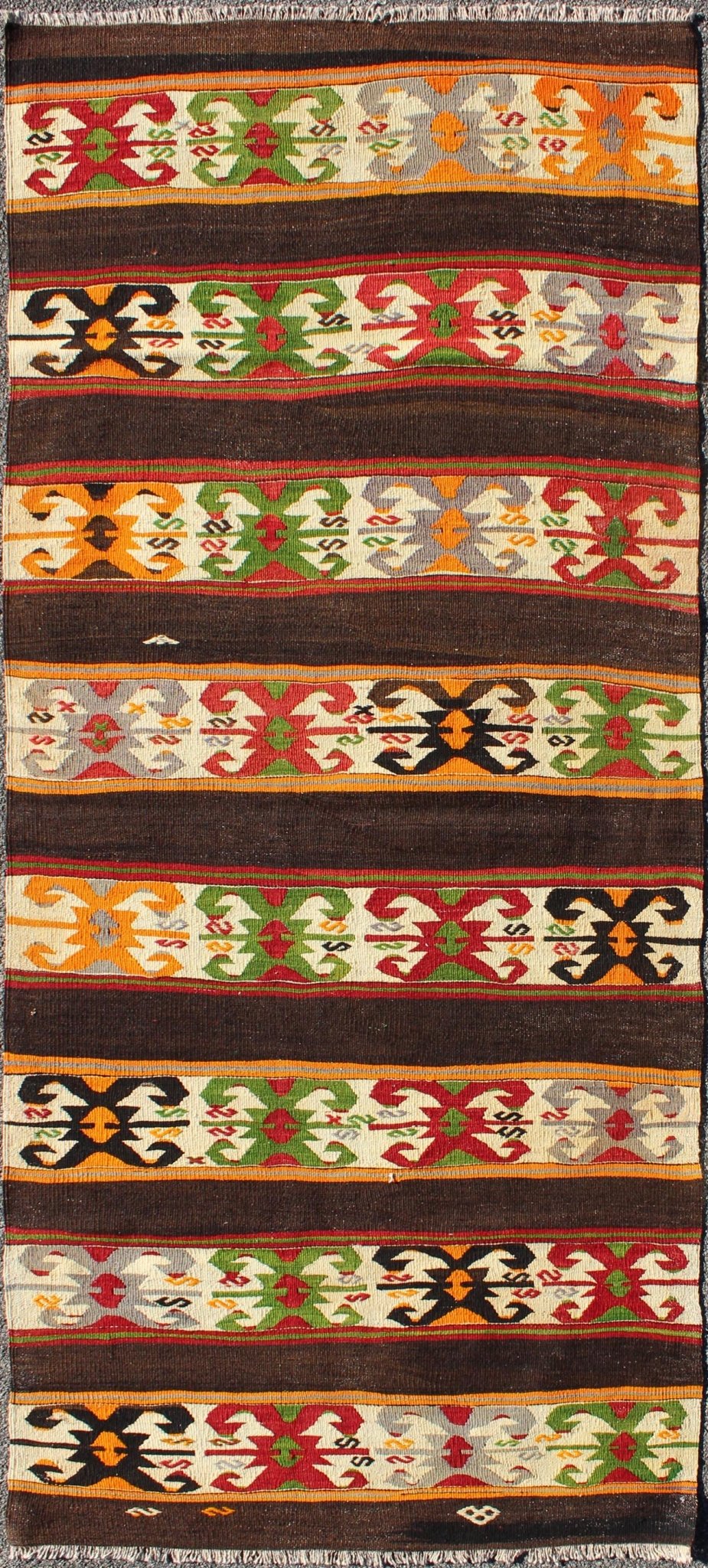 Keivan Woven Arts - Vintage Turkish Kilim rug with Vivid colors and tribal stripes on charcoal background, rug TU - NED - 132, country of origin / type: Turkey / Kilim, circa mid - 20th century. Featuring tribal elements rendered in a repeating horizon... - Keivan Woven ArtsTU - NED - 132 - 3576Rug