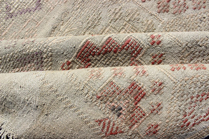 Vintage Turkish Kilim Featuring Muted Colors and All - Over Tribal Motif Design Measures 4'7 x 8'0 This rug features an asymmetrical design of tribal crests decorating the light blue - grey field. The crests are rendered in varying muted shades ... - Keivan Woven ArtsTU - NED - 136032 - 4618Rug
