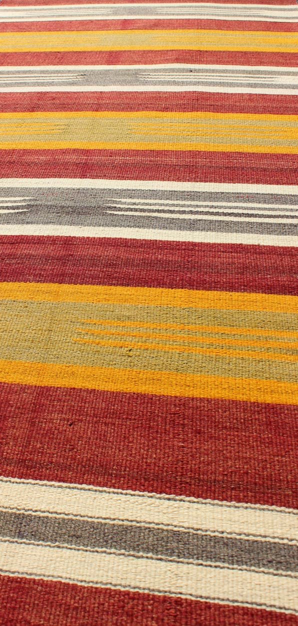 Vintage Turkish Kilim Runner with Stripes in Red, Green, Yellow, Ivory, Gray, rug ned - 145, country of origin / type: Turkey / Kilim, circa mid - 20th century. Woven during the mid - 20th century in Turkey, this designer Kilim is decorated with a hor... - Keivan Woven ArtsTU - NED - 145 - 3572Rug