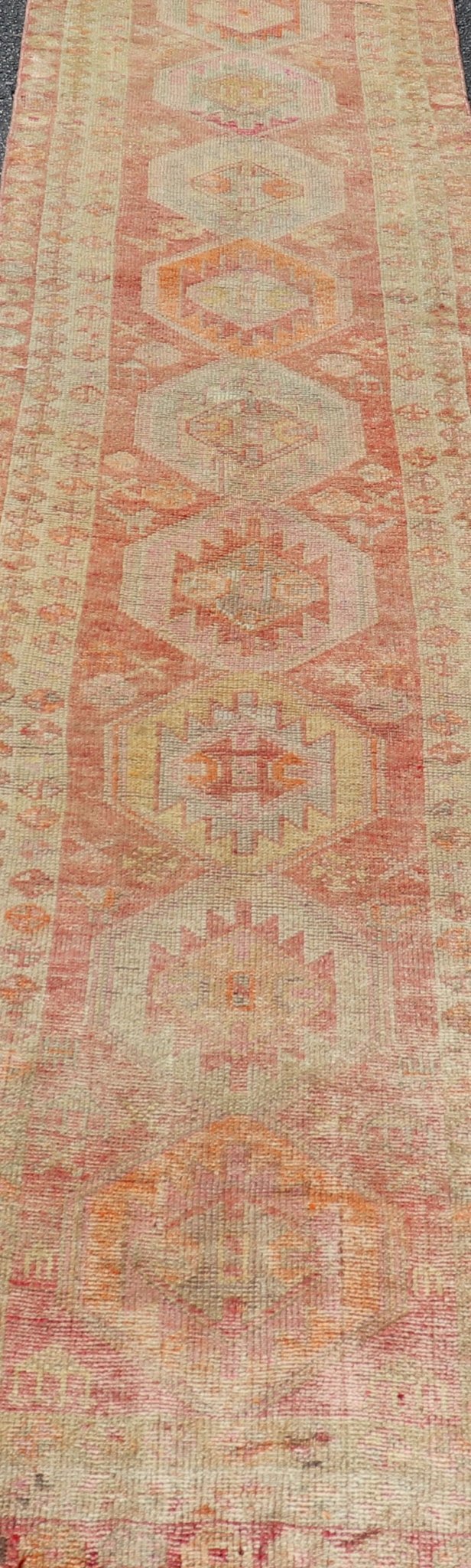 Vintage Long Turkish Oushak Runner with Tribal Medallions in Soft Red. Keivan Woven Arts / rug TU - NED - 4650, country of origin / type: Turkey / Oushak, circa 1950 Measures: 2'6 x 14'0 This vintage Turkish Oushak rug features a multi - medal... - Keivan Woven ArtsTU - NED - 4650 - 23054Rug