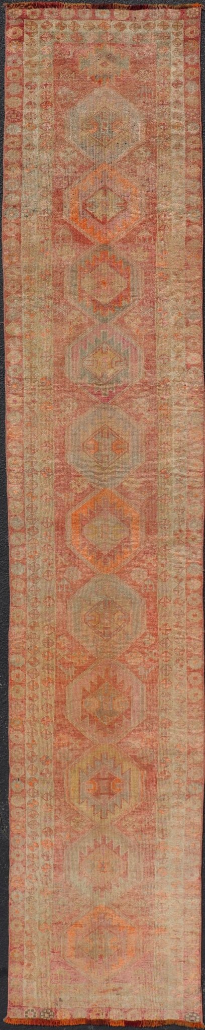 Vintage Long Turkish Oushak Runner with Tribal Medallions in Soft Red. Keivan Woven Arts / rug TU - NED - 4650, country of origin / type: Turkey / Oushak, circa 1950 Measures: 2'6 x 14'0 This vintage Turkish Oushak rug features a multi - medal... - Keivan Woven ArtsTU - NED - 4650 - 23054Rug