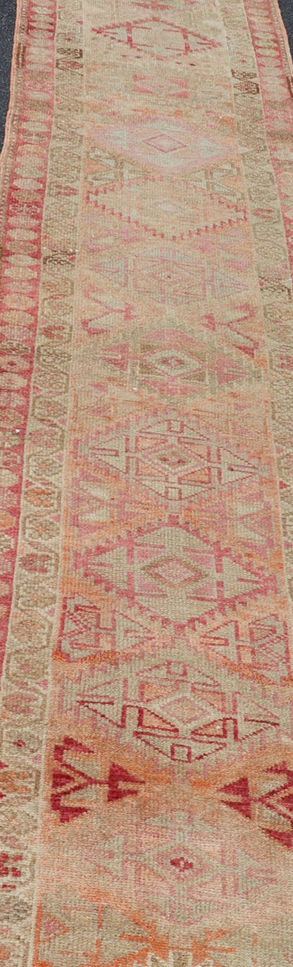 Measures: 2'8 x 14'0 Vintage Oushak Runner with Geometric Medallions in Soft Coral and Orange. Keivan Woven Arts / rug TU - NED - 4680, country of origin / type: Turkey / Oushak, circa 1960 This Oushak runner from Turkey features a creative design c... - Keivan Woven ArtsTU - NED - 4680 - 23066Rug