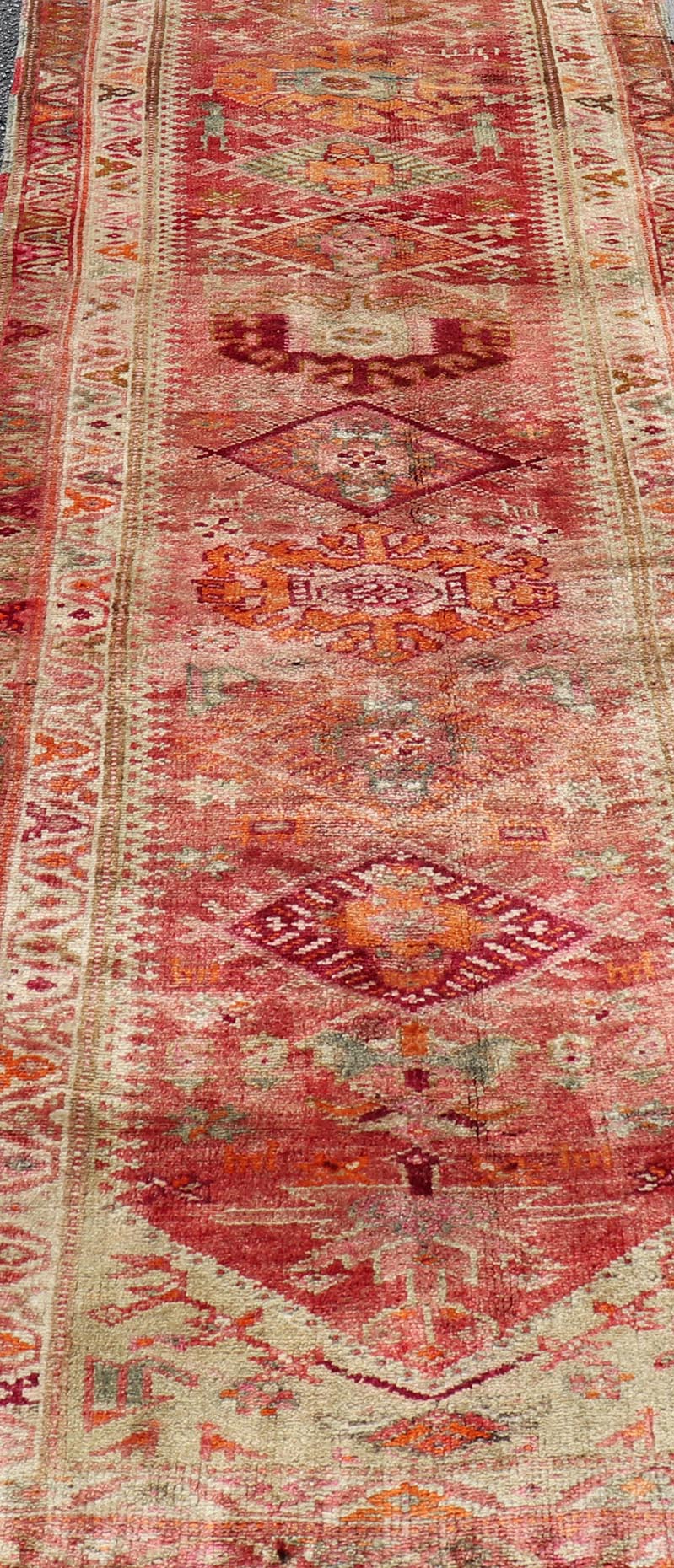 Measures: 3'0 x 15'8 Vintage Turkish Oushak Runner with Geometric Medallion Design in Muted Coral. Keivan Woven Arts / rug TU - NED - 4682, country of origin / type: Turkey / Oushak, circa 1960 This beautiful vintage Oushak runner from 1960s Turkey ... - Keivan Woven ArtsTU - NED - 4682 - 21379Rug