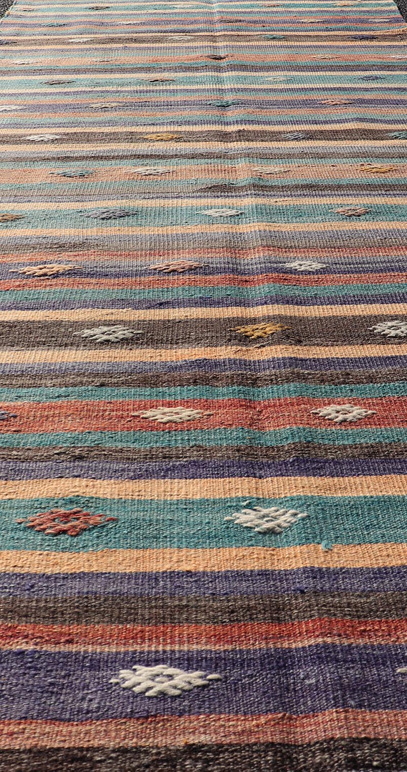 Measures: 3'3 x 10'10 Colorful Vintage Embroidered Kilim Runner with Stripe's and Geometric. Keivan Woven Arts / rug TU - NED - 5003, country of origin / type: Turkey / Kilim, circa 1950 This vintage Kilim displays an array of designs, including... - Keivan Woven ArtsTU - NED - 5003 - 22183Rug