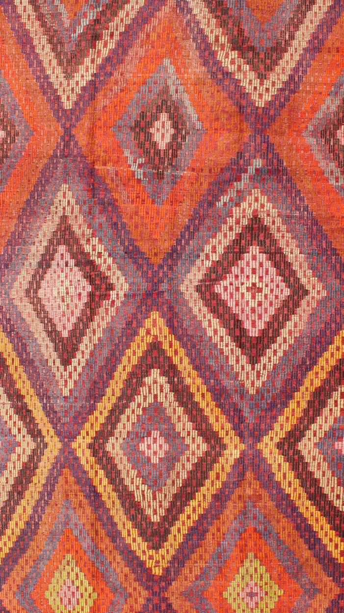 Measures: 5'7 x 10'5. Featuring a large diamond pattern with a spotted and speckled assortment of geometric checkered elements, this uniquely embroidered Kilim showcases an array saturated colors. The colors include blue, gray, red, yellow, brown, o... - Keivan Woven ArtsTU - NED - 561 - 6895Rug