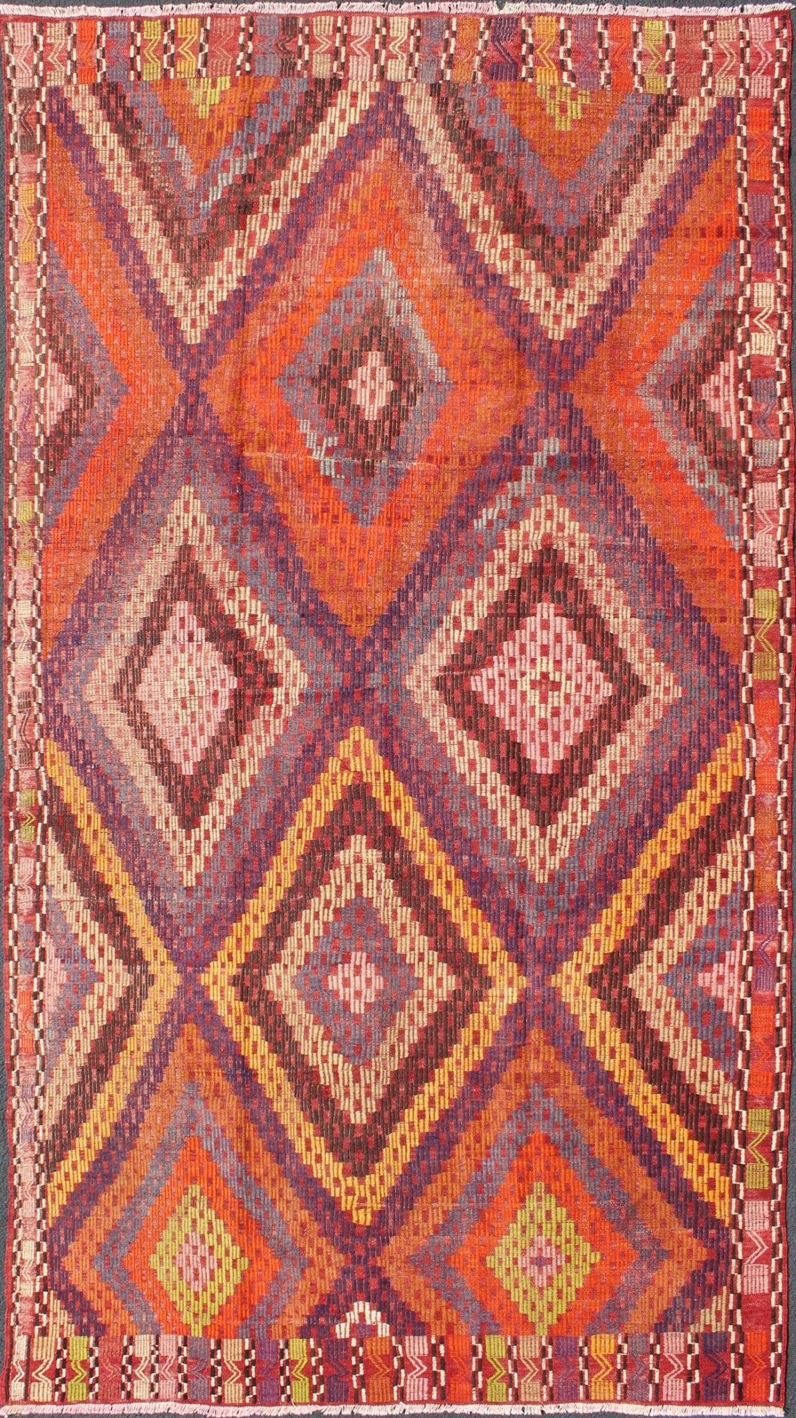 Measures: 5'7 x 10'5. Featuring a large diamond pattern with a spotted and speckled assortment of geometric checkered elements, this uniquely embroidered Kilim showcases an array saturated colors. The colors include blue, gray, red, yellow, brown, o... - Keivan Woven ArtsTU - NED - 561 - 6895Rug