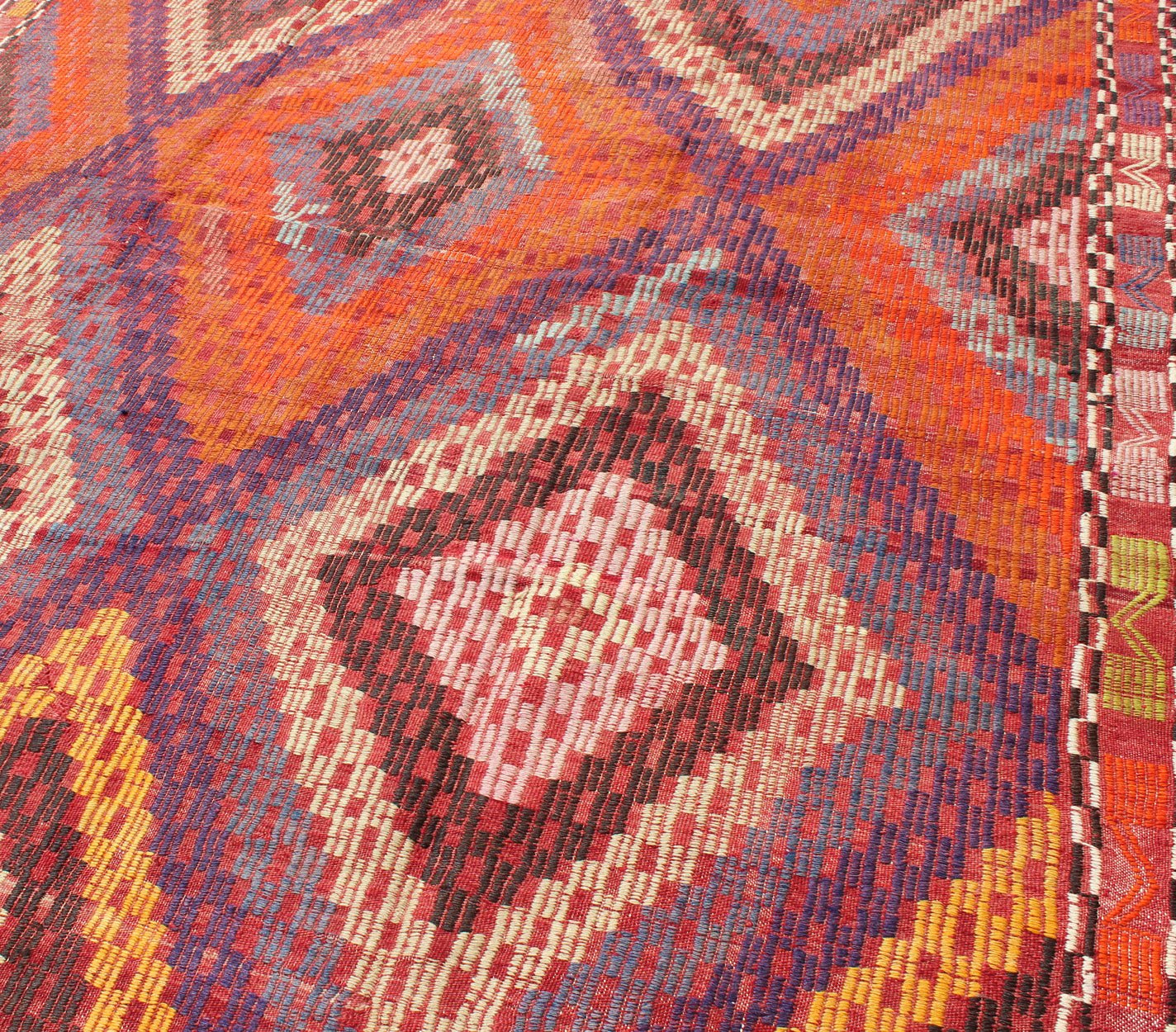 Measures: 5'7 x 10'5. Featuring a large diamond pattern with a spotted and speckled assortment of geometric checkered elements, this uniquely embroidered Kilim showcases an array saturated colors. The colors include blue, gray, red, yellow, brown, o... - Keivan Woven ArtsTU - NED - 561 - 6895Rug