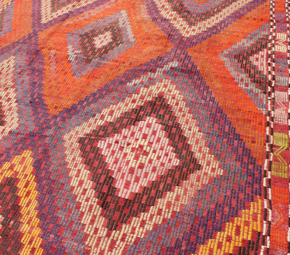 Measures: 5'7 x 10'5. Featuring a large diamond pattern with a spotted and speckled assortment of geometric checkered elements, this uniquely embroidered Kilim showcases an array saturated colors. The colors include blue, gray, red, yellow, brown, o... - Keivan Woven ArtsTU - NED - 561 - 6895Rug