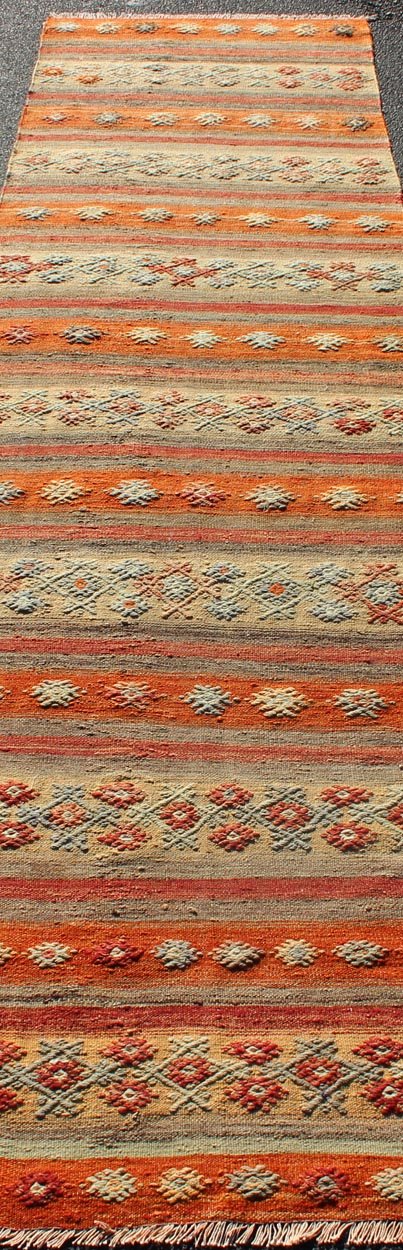 Colorful Vintage Turkish Kilim Runner with Stripes and Geometric Embroideries Vintage Turkish Kilim runner with horizontal stripes and scattered geometric shapes in embroideries , rug ned - 124, country of origin / type: Turkey / Kilim, circa mid - 20t... - Keivan Woven ArtsTU - NED - 608 - 12463Rug