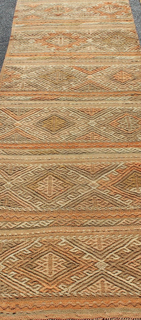 Turkish Kilim vintage carpet in taupe, tan, orange, Keivan Woven Arts / rug TU - NED - 621, country of origin / type: Turkey / Kilim, circa 1950 This Kilim rug from Turkey features a striped design of various geometric patterns rendered in shades of... - Keivan Woven ArtsTU - NED - 621 - 12487Rug