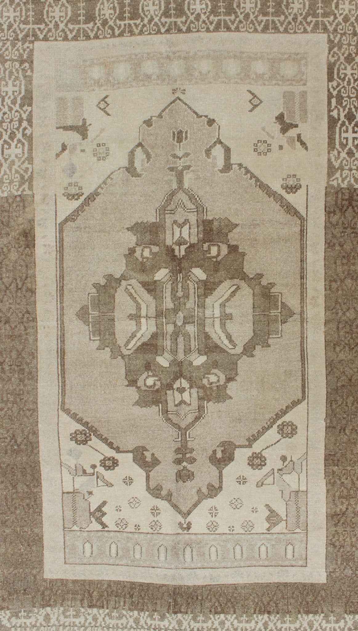 This Vintage Turkish Oushak is set on a taupe background. The geometric medallion features light green and brown with accents of darker brown. The border is very modern with unique motifs, while the overall feel of the piece is muted and contemporary. ... - Keivan Woven ArtsTU - TRS - 112964 - 3594Rug