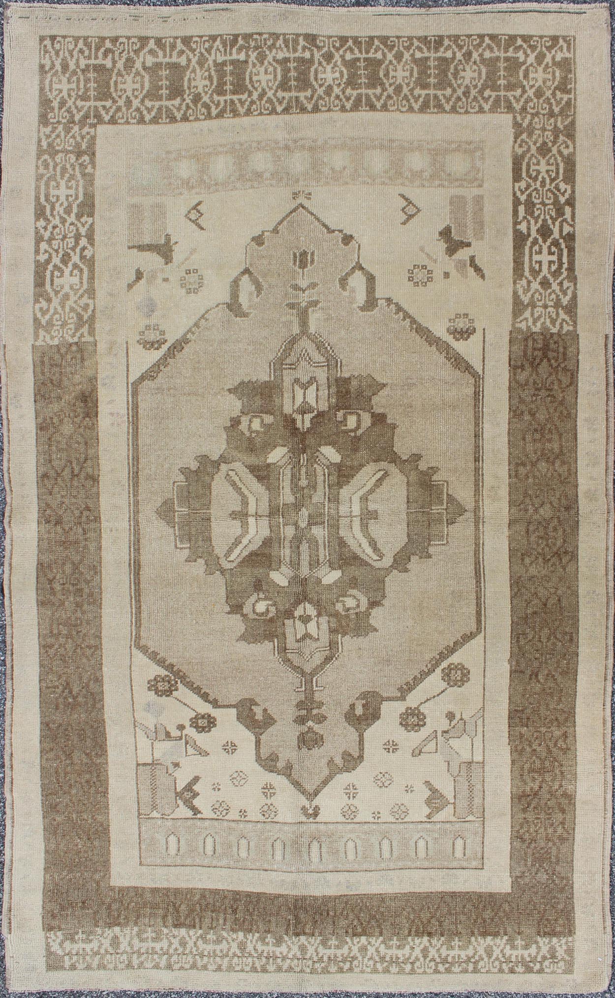 This Vintage Turkish Oushak is set on a taupe background. The geometric medallion features light green and brown with accents of darker brown. The border is very modern with unique motifs, while the overall feel of the piece is muted and contemporary. ... - Keivan Woven ArtsTU - TRS - 112964 - 3594Rug