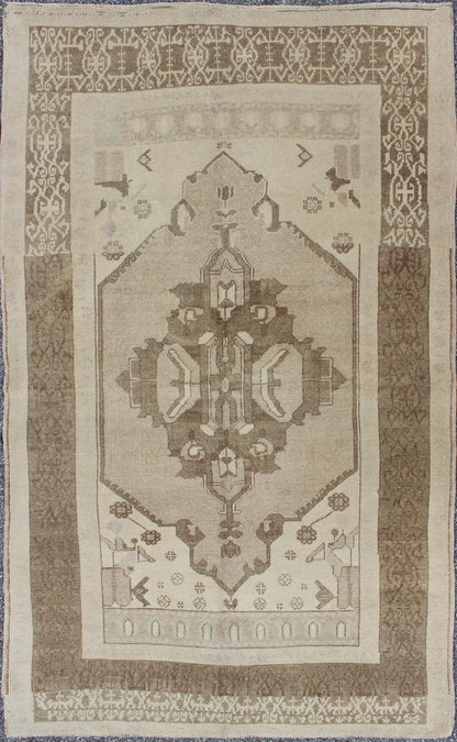This Vintage Turkish Oushak is set on a taupe background. The geometric medallion features light green and brown with accents of darker brown. The border is very modern with unique motifs, while the overall feel of the piece is muted and contemporary. ... - Keivan Woven ArtsTU - TRS - 112964 - 3594Rug