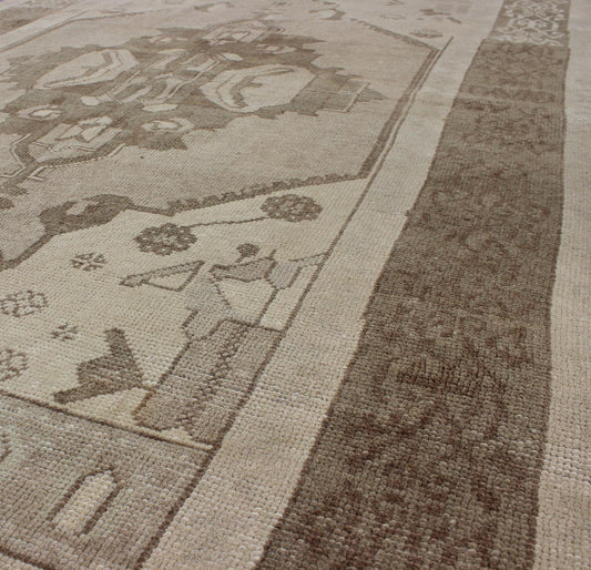 This Vintage Turkish Oushak is set on a taupe background. The geometric medallion features light green and brown with accents of darker brown. The border is very modern with unique motifs, while the overall feel of the piece is muted and contemporary. ... - Keivan Woven ArtsTU - TRS - 112964 - 3594Rug