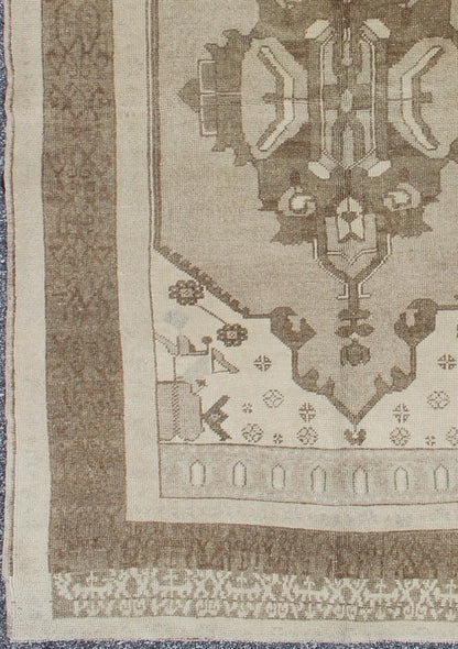 This Vintage Turkish Oushak is set on a taupe background. The geometric medallion features light green and brown with accents of darker brown. The border is very modern with unique motifs, while the overall feel of the piece is muted and contemporary. ... - Keivan Woven ArtsTU - TRS - 112964 - 3594Rug